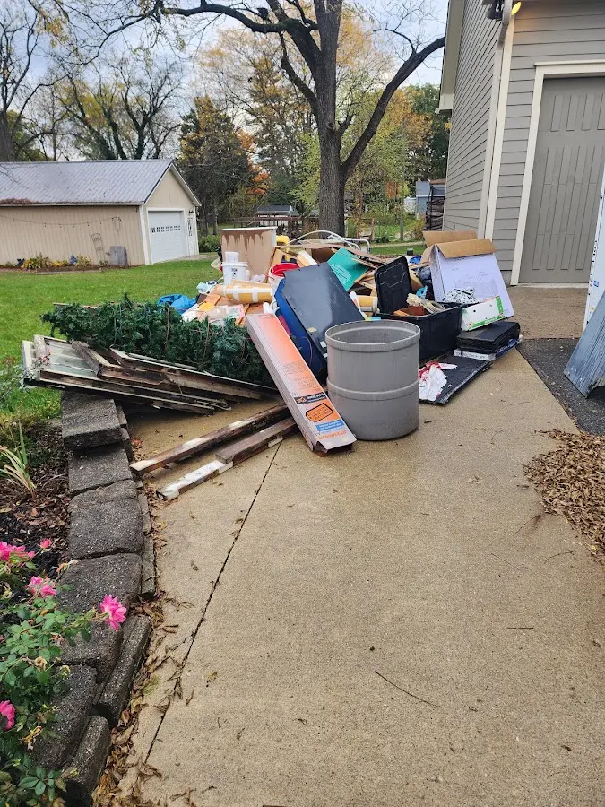 Dumpster being loaded with debris for Estate Cleanout Dumpster Rental in Neptune City